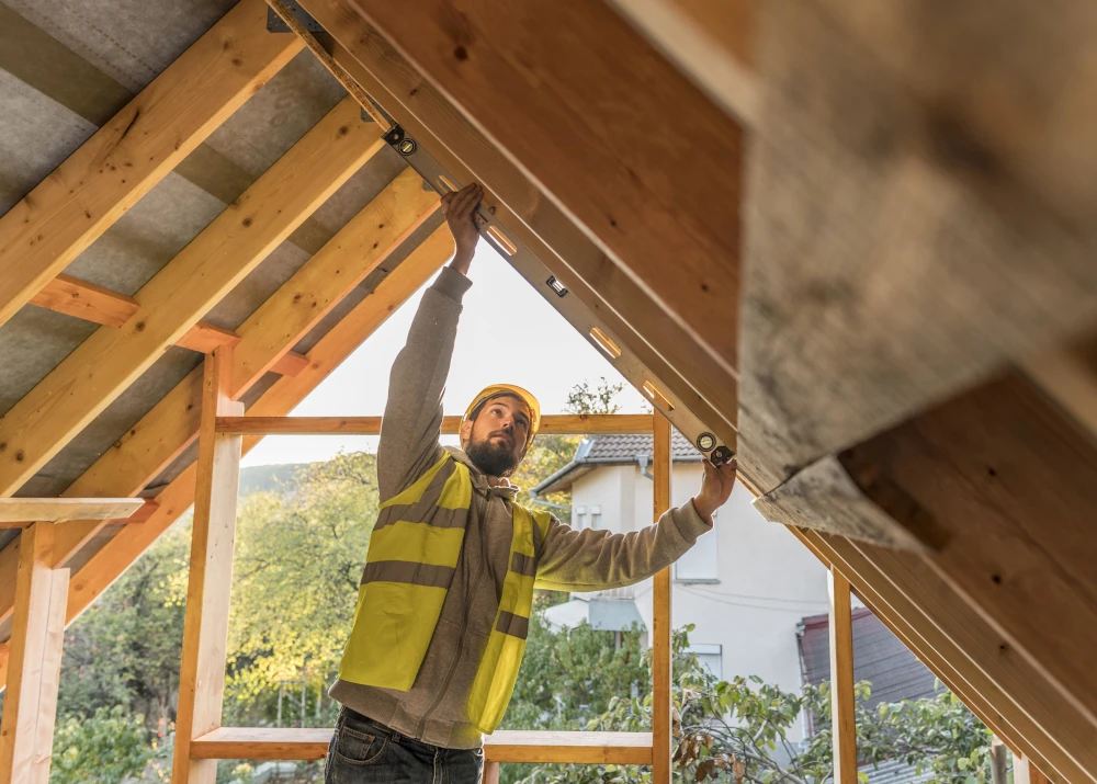 Carpenter working on a roof of a home expansion, representing the importance of choosing the right contractor to carry out the construction or renovation of your home.